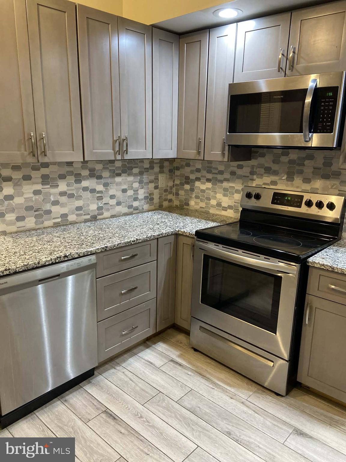 1416 East 5th Street Bethlehem, PA 18015 - Photo 6 of 26 a kitchen with granite countertop a stove microwave and oven