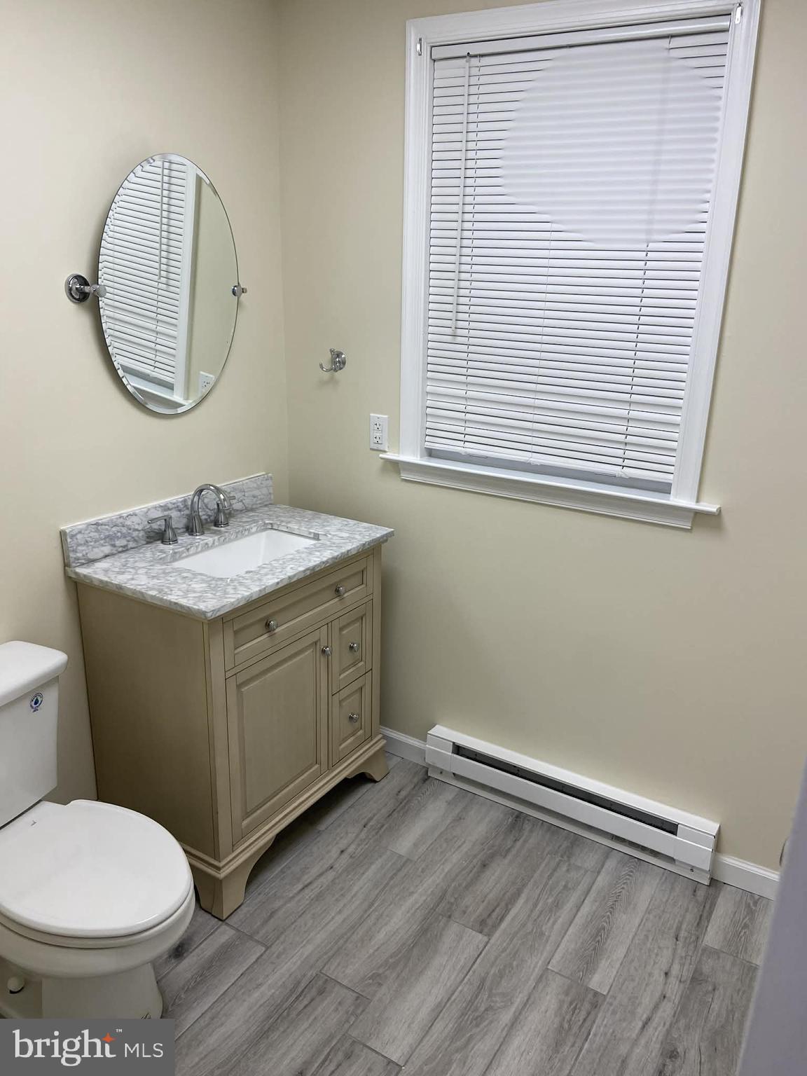 1416 East 5th Street Bethlehem, PA 18015 - Photo 9 of 26 a bathroom with a toilet sink and mirror