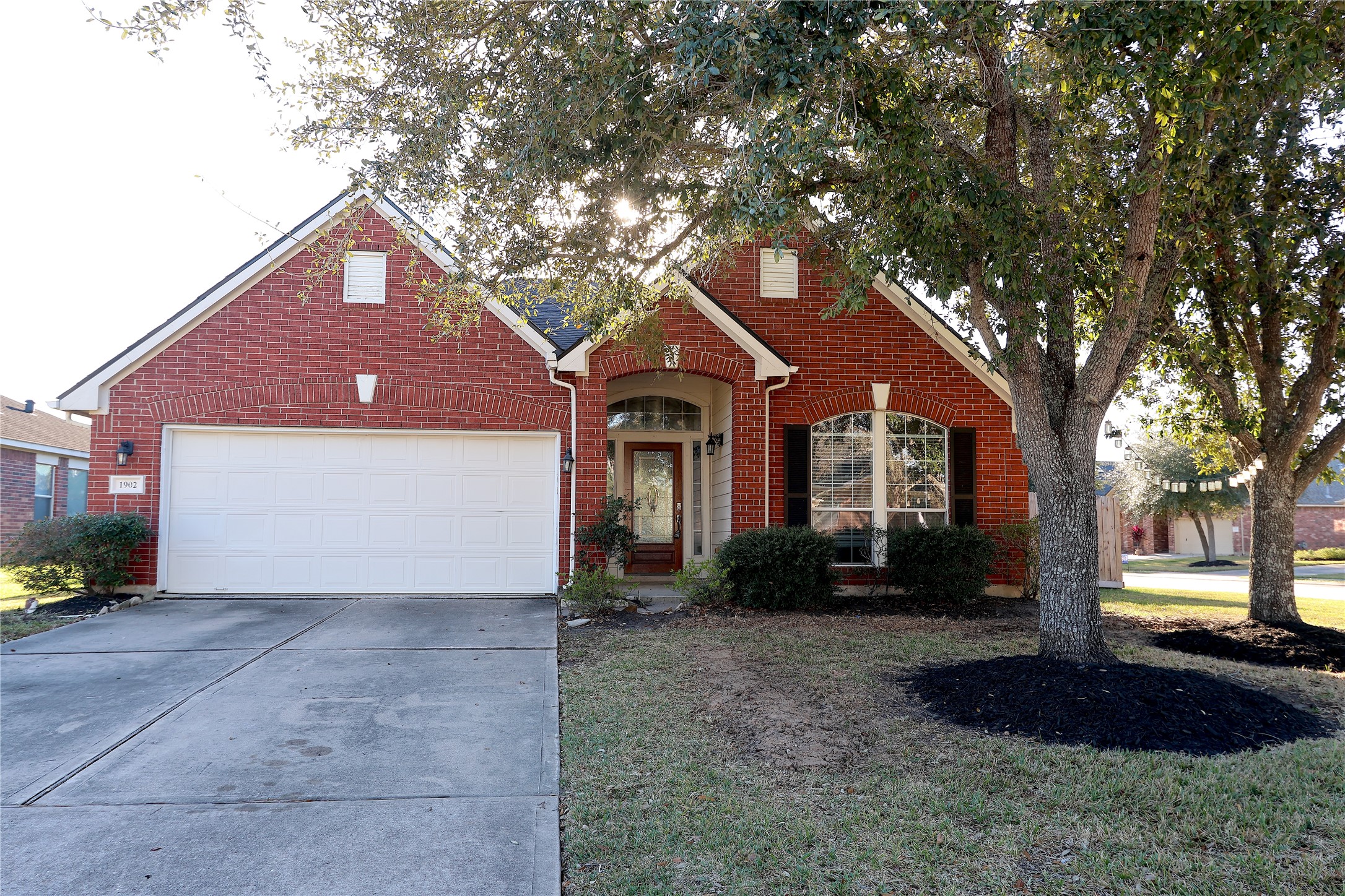 1902 Lantana Spring Lane Pearland, TX 77581 - Photo 1 of 18 a front view of a house with a yard and garage