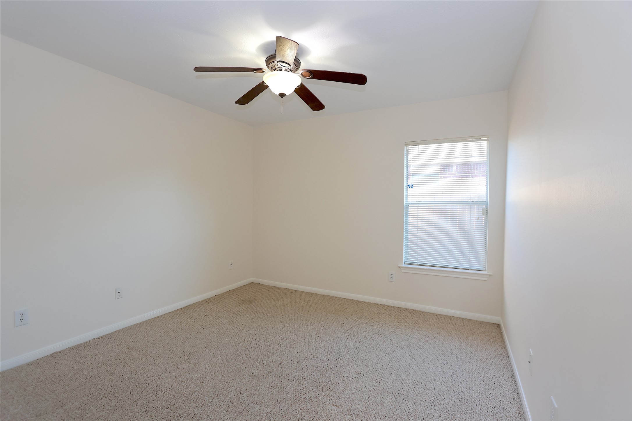 1902 Lantana Spring Lane Pearland, TX 77581 - Photo 14 of 18 an empty room with a chandelier fan and windows