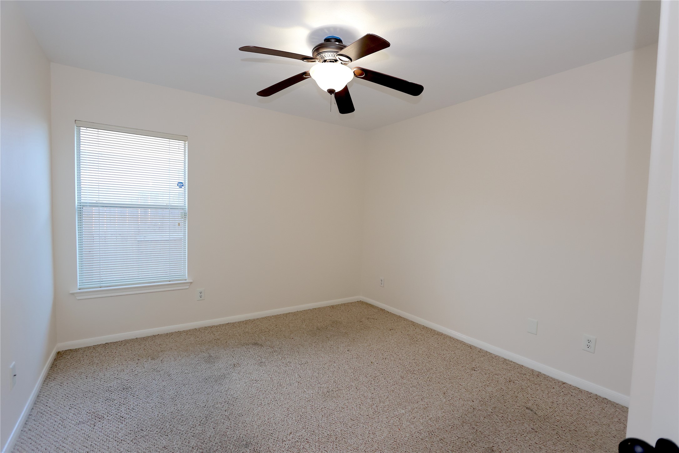 1902 Lantana Spring Lane Pearland, TX 77581 - Photo 16 of 18 an empty room with a window and a ceiling fan