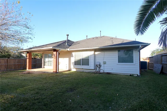 a front view of a house with a garden and yard