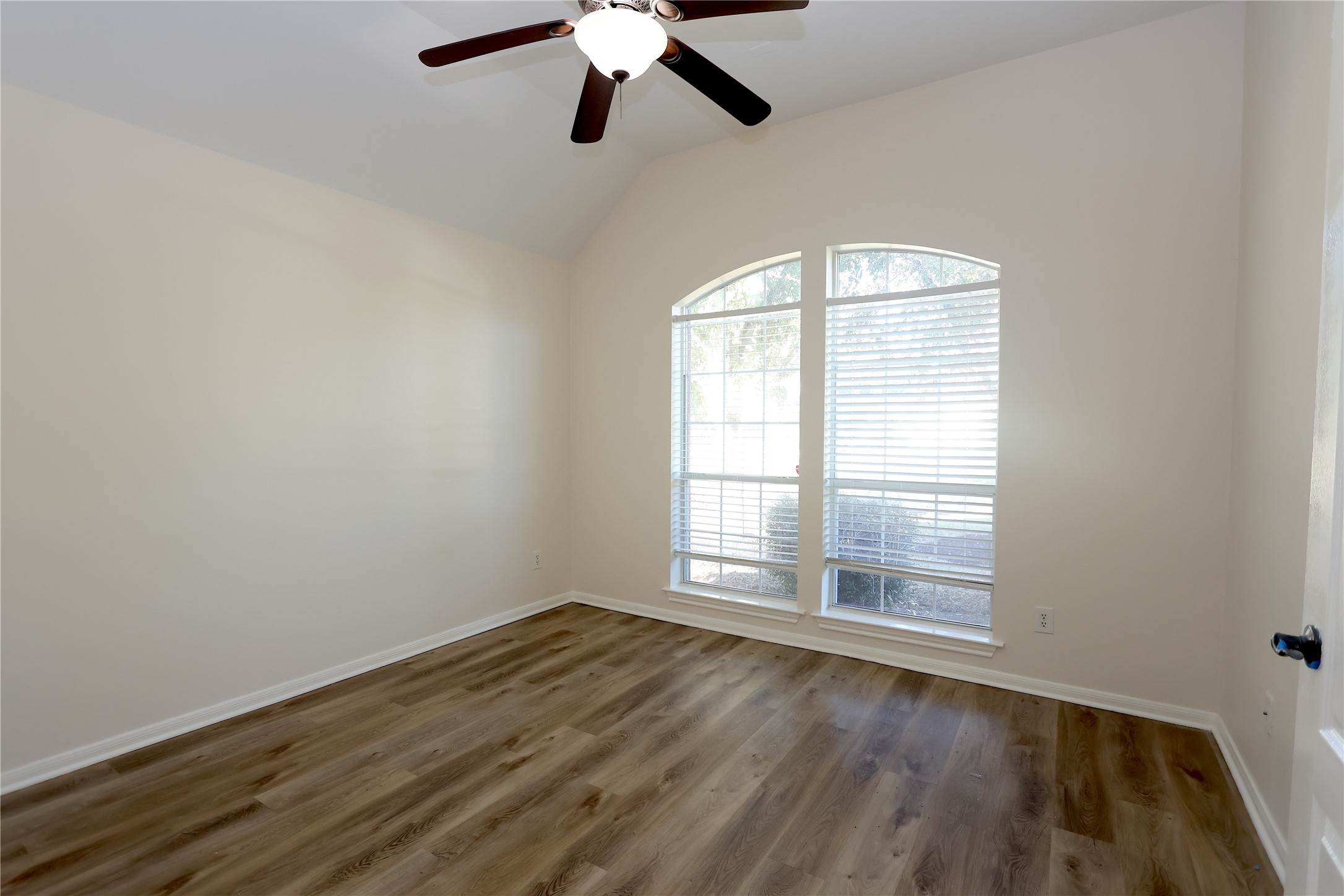 1902 Lantana Spring Lane Pearland, TX 77581 - Photo 3 of 18 an empty room with wooden floor fan and windows