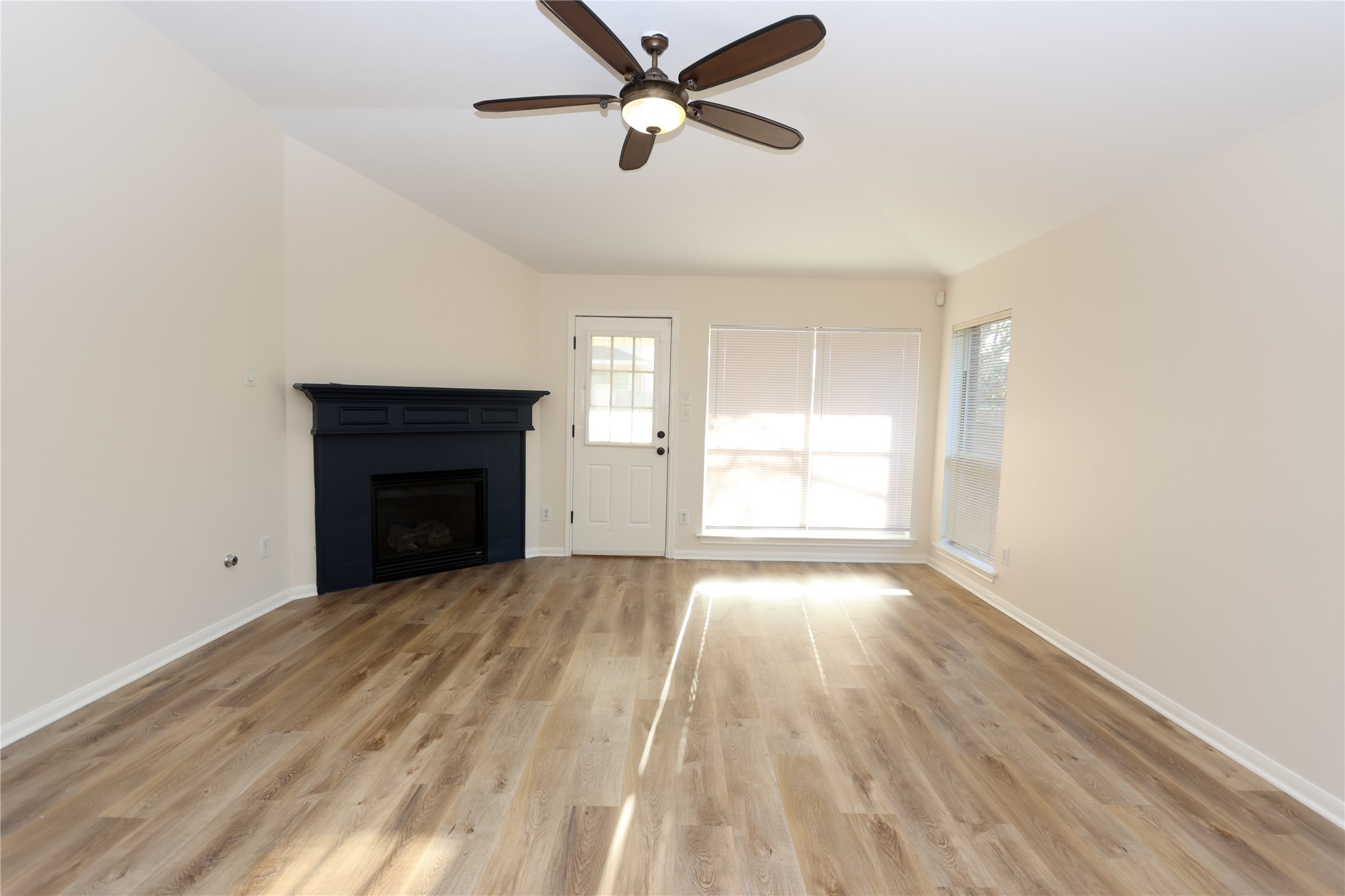 1902 Lantana Spring Lane Pearland, TX 77581 - Photo 5 of 18 a view of empty room with wooden floor and fan