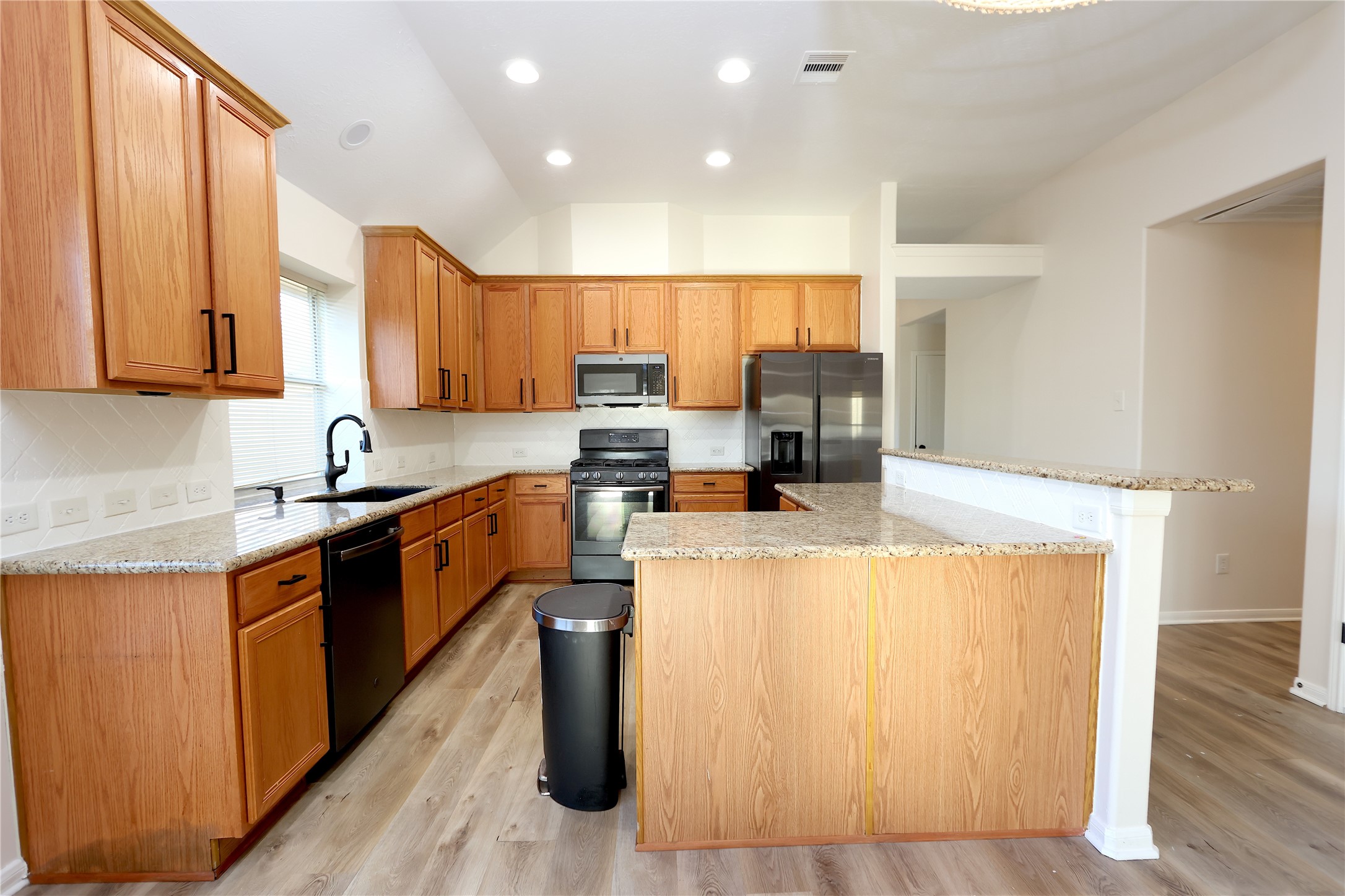 1902 Lantana Spring Lane Pearland, TX 77581 - Photo 6 of 18 a kitchen with stainless steel appliances a refrigerator a sink a stove top oven a counter space and cabinets