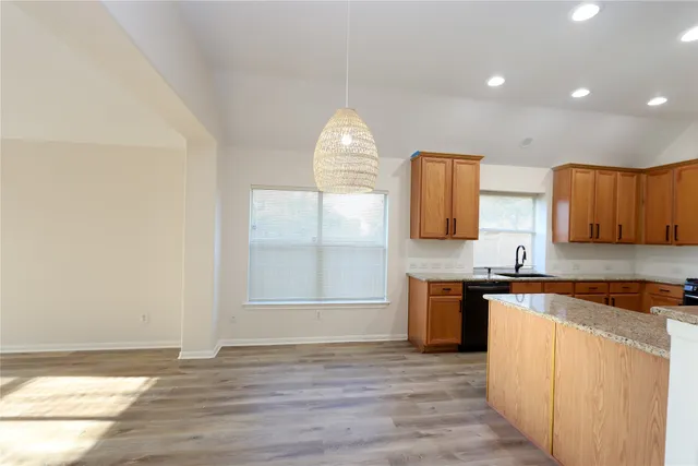 an empty room with wooden floor and cabinet
