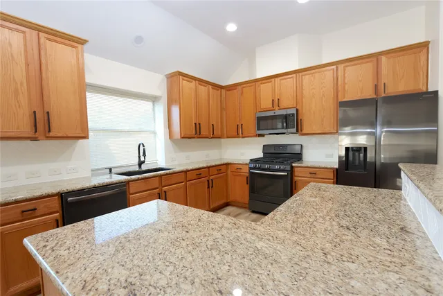 a kitchen with stainless steel appliances granite countertop a stove top oven a sink dishwasher and microwave oven