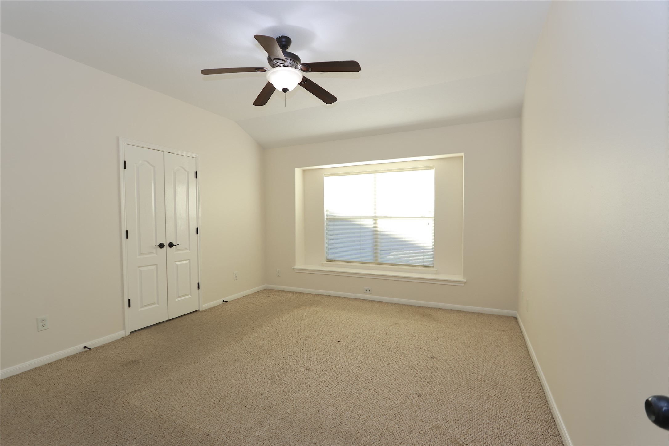 1902 Lantana Spring Lane Pearland, TX 77581 - Photo 9 of 18 an empty room with a window and a fan