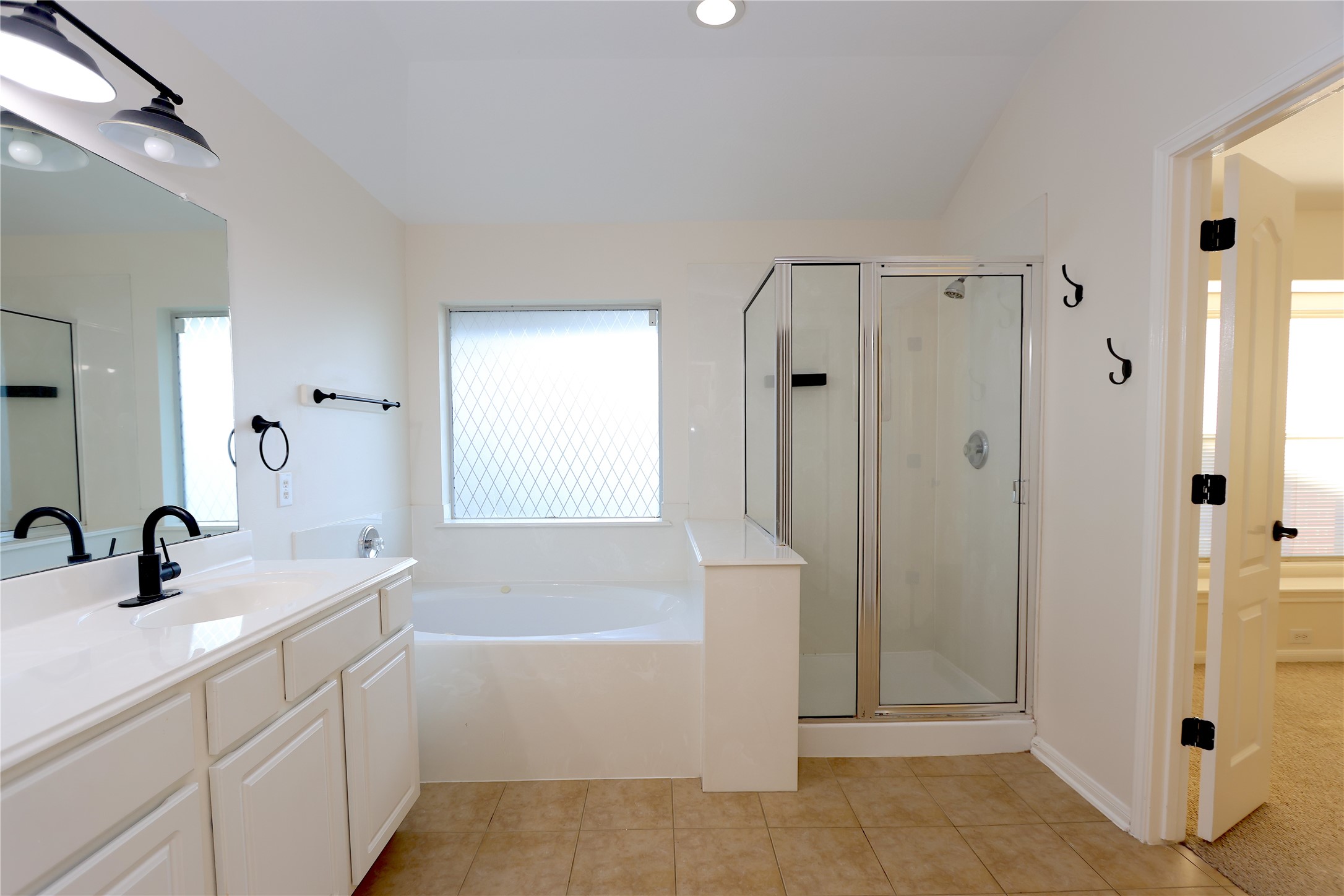 1902 Lantana Spring Lane Pearland, TX 77581 - Photo 10 of 18 a bathroom with a tub sink shower and mirror