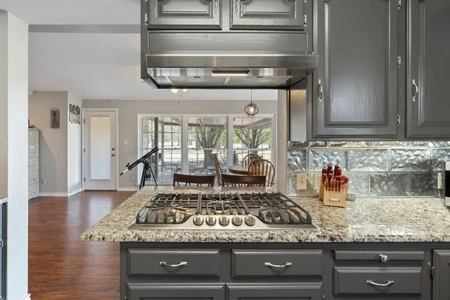 a stove top oven sitting inside of a kitchen