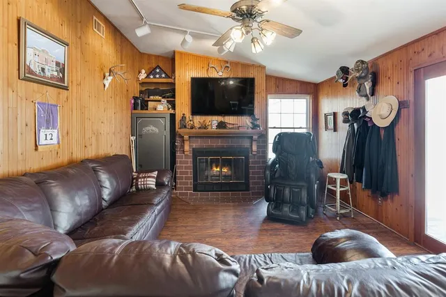a living room with furniture a flat screen tv and a fireplace