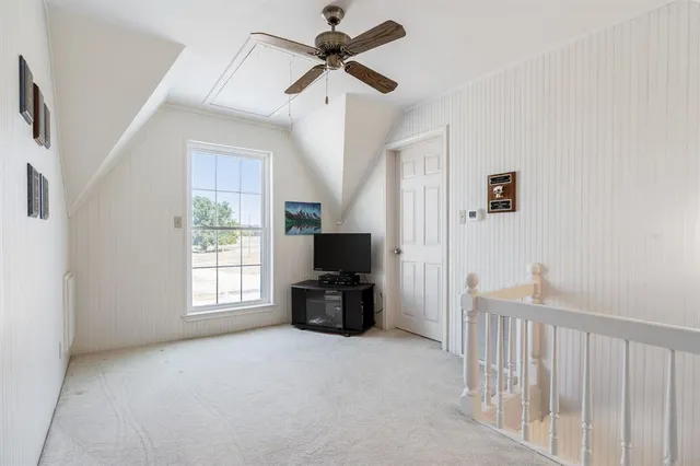 a view of a livingroom with a ceiling fan and window