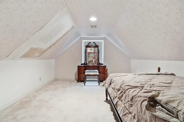 a bedroom with a bed and a lamp on roof