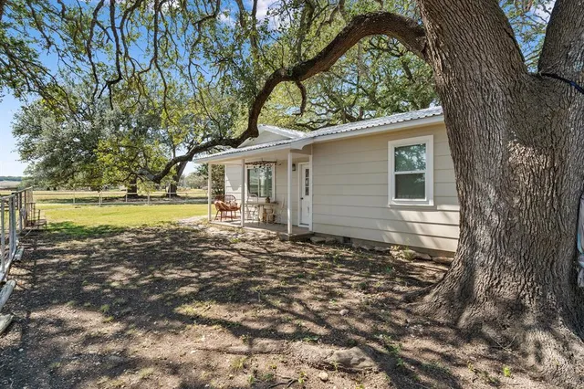 a view of a house with garden and sitting area