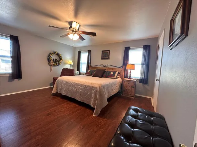 a bedroom with a bed window and a wall painting