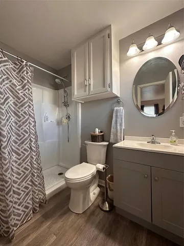 a bathroom with a sink toilet and a mirror