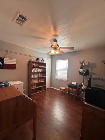 a view of a livingroom with furniture and chandelier fan