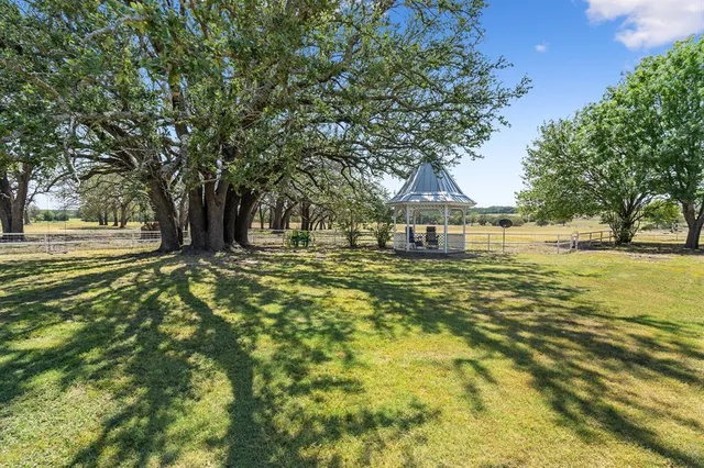 a view of yard with swimming pool and trees