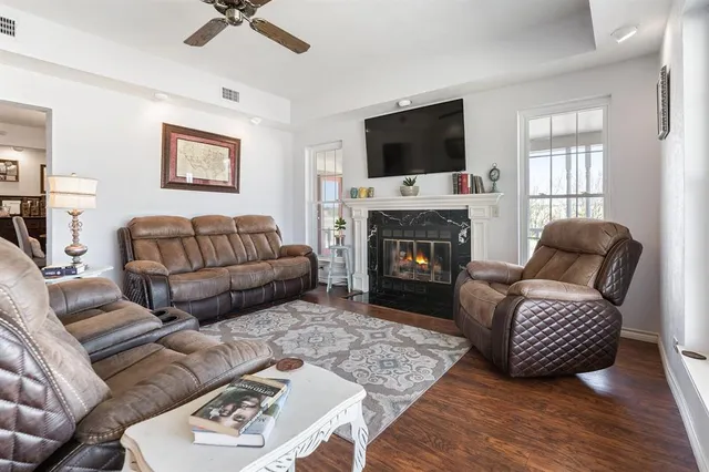 a living room with furniture a flat screen tv and a fireplace