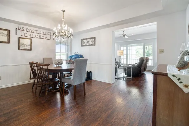 a view of a dining room with furniture wooden floor and chandelier