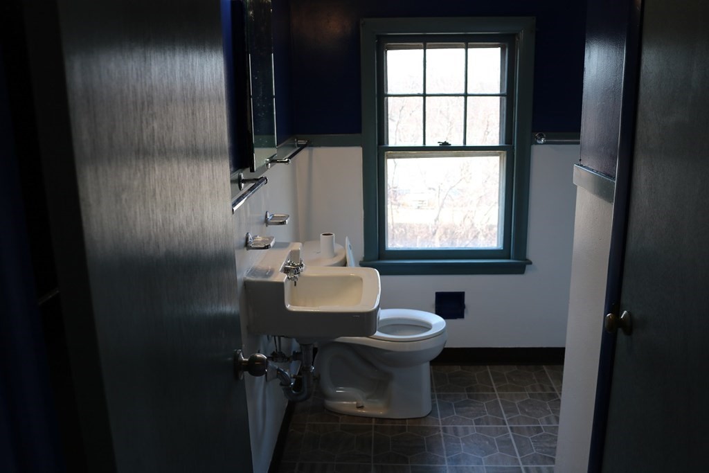 172 East Allen Ridge Road Springfield, MA 01118 - Photo 11 of 20 a bathroom with a sink toilet a mirror and window