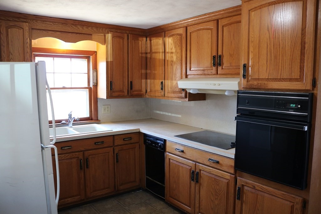 172 East Allen Ridge Road Springfield, MA 01118 - Photo 2 of 20 a kitchen with stainless steel appliances granite countertop wooden cabinets a sink and a window