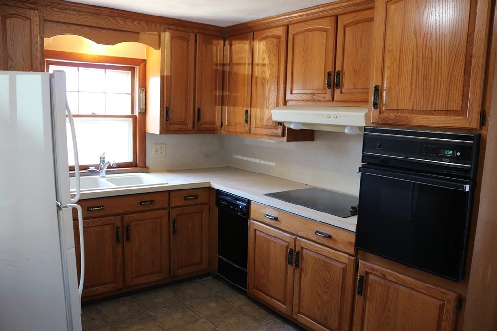 172 East Allen Ridge Road Springfield, MA 01118 - Photo 3 of 20 a kitchen with granite countertop cabinets stainless steel appliances a sink and a window