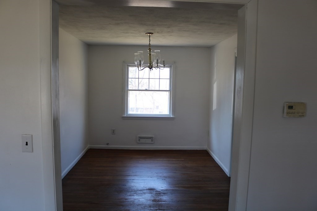 172 East Allen Ridge Road Springfield, MA 01118 - Photo 4 of 20 an empty room with wooden floor and windows