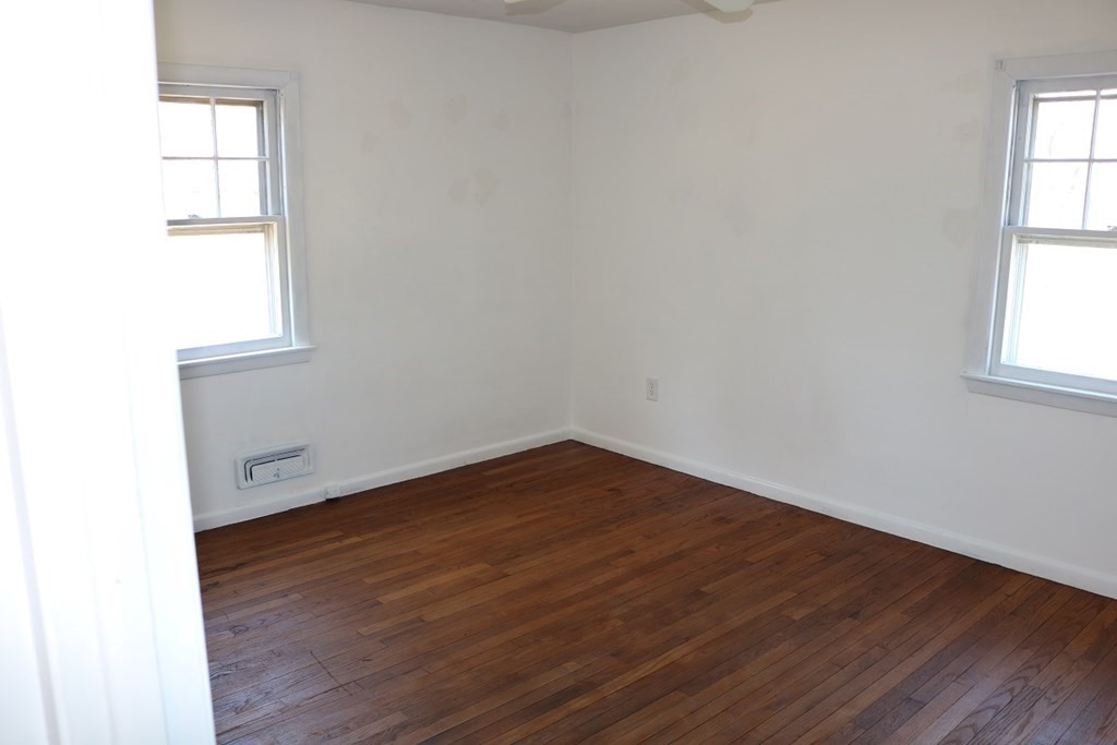 172 East Allen Ridge Road Springfield, MA 01118 - Photo 9 of 20 an empty room with wooden floor and windows