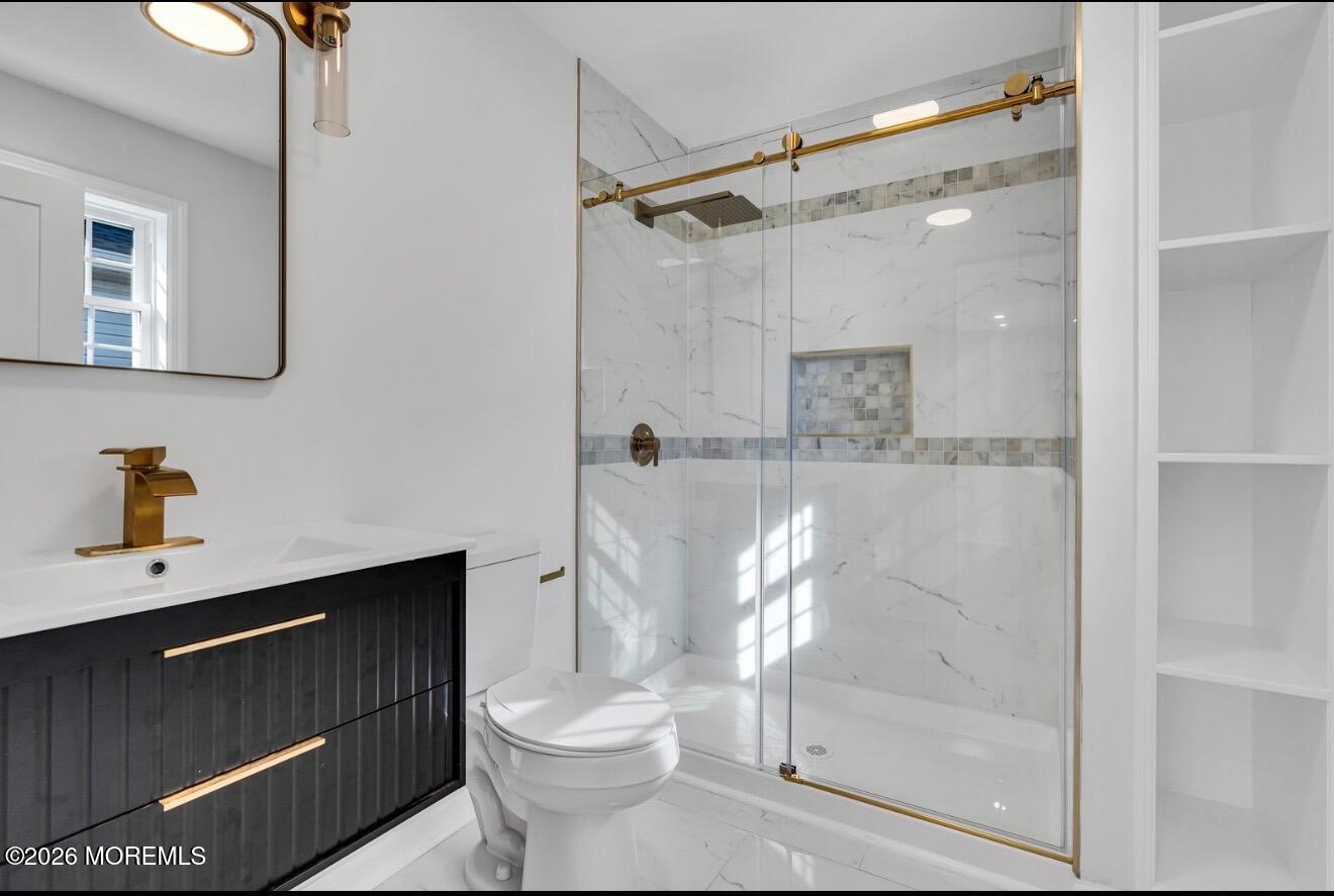 214 Raritan Street Union Beach, NJ 07735 - Photo 4 of 10 a bathroom with a toilet a sink and shower