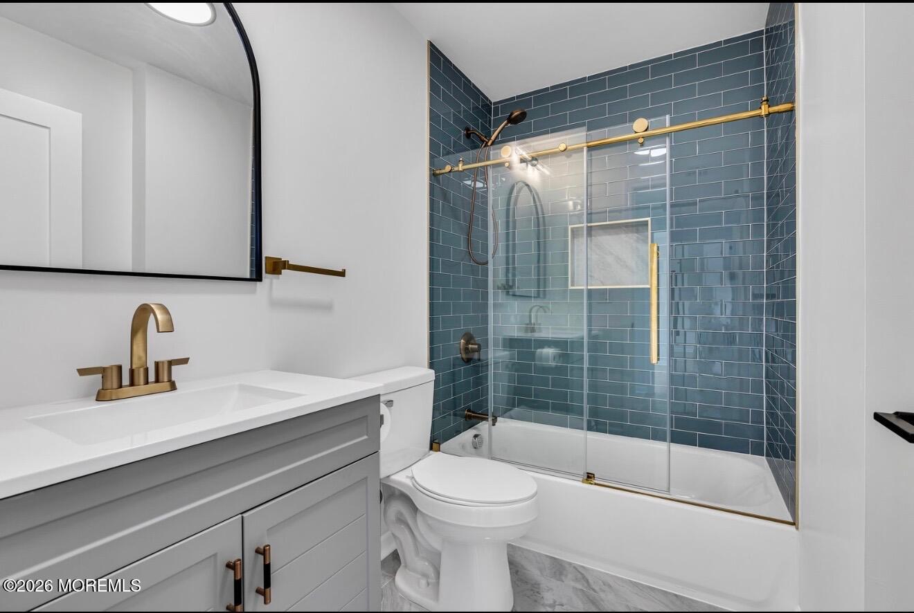 214 Raritan Street Union Beach, NJ 07735 - Photo 8 of 10 a bathroom with a sink a toilet and shower