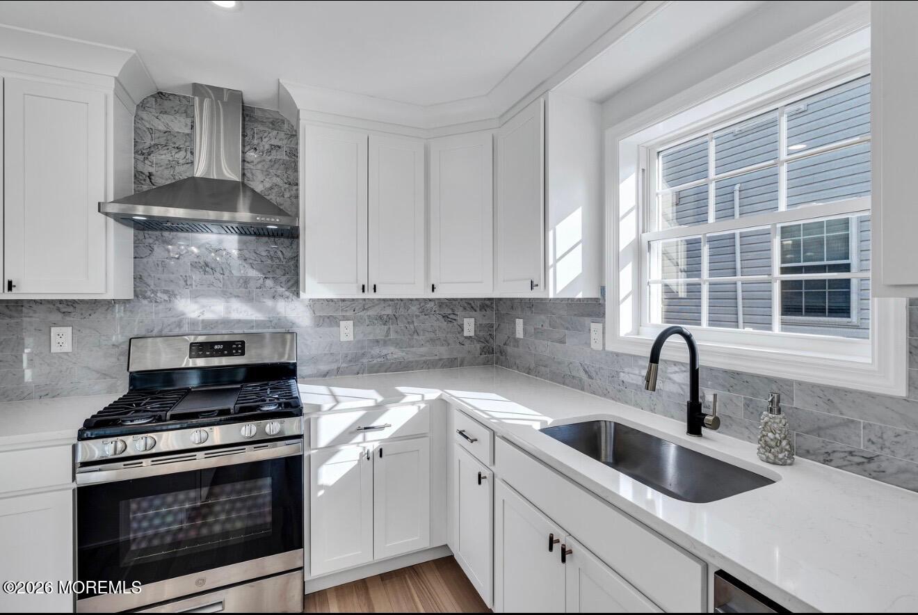214 Raritan Street Union Beach, NJ 07735 - Photo 9 of 10 a kitchen with granite countertop a sink stove and cabinets