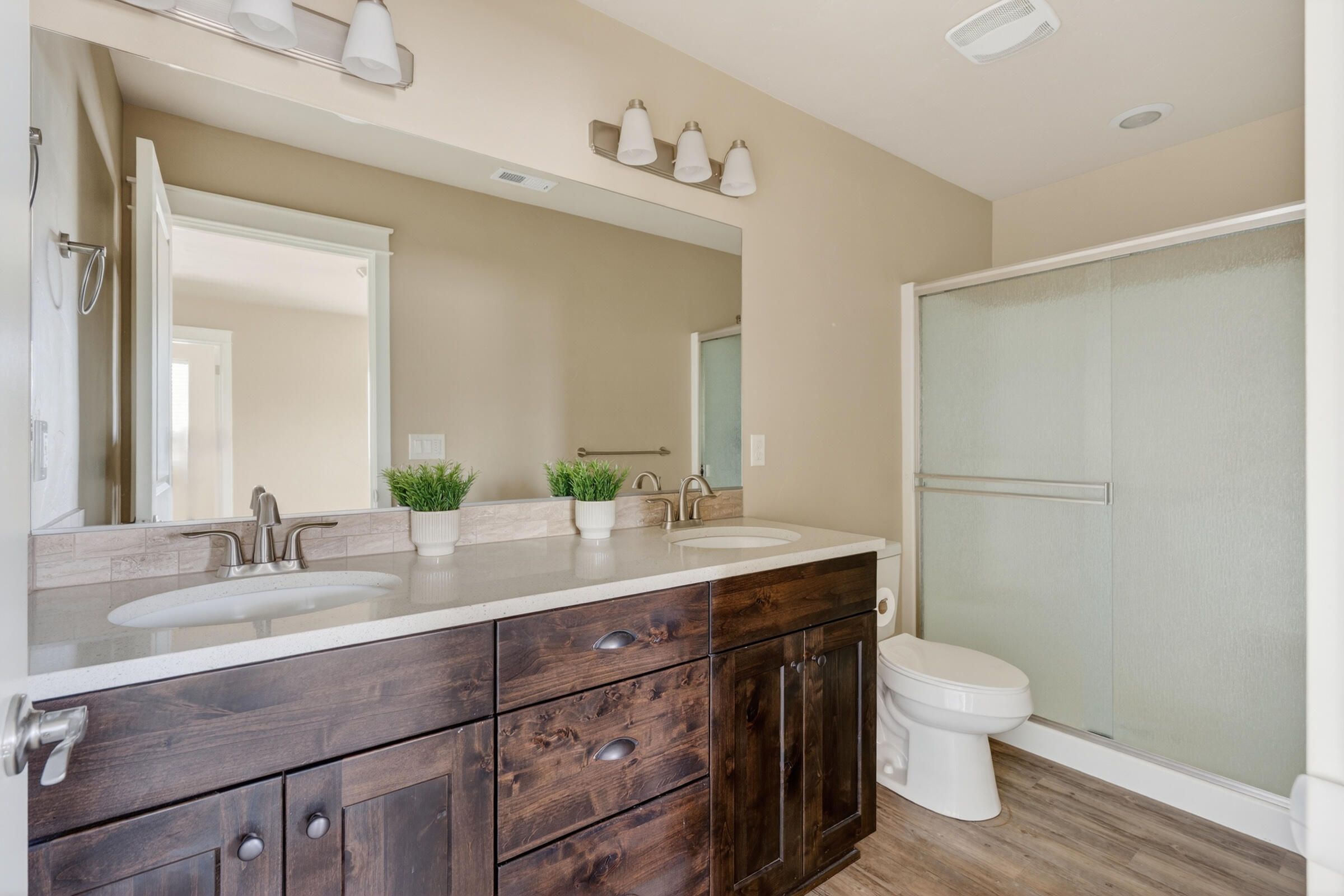 3365 Southwest 28th Street Redmond, OR 97756 - Photo 18 of 39 a bathroom with a granite countertop sink a toilet and a mirror