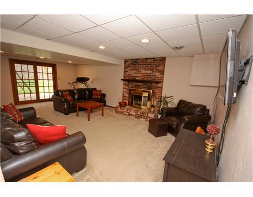 24 Barnhart Street Rural Ridge, PA 15075 - Photo 11 of 18 Den/Family/Great Room. This house feautres plenty of entertaining space! The finished basement features a brick fireplace and recessed lights. This is a walkout basement to the backyard. Glass doors welcome natural light! There is a full bathroom in the basement.