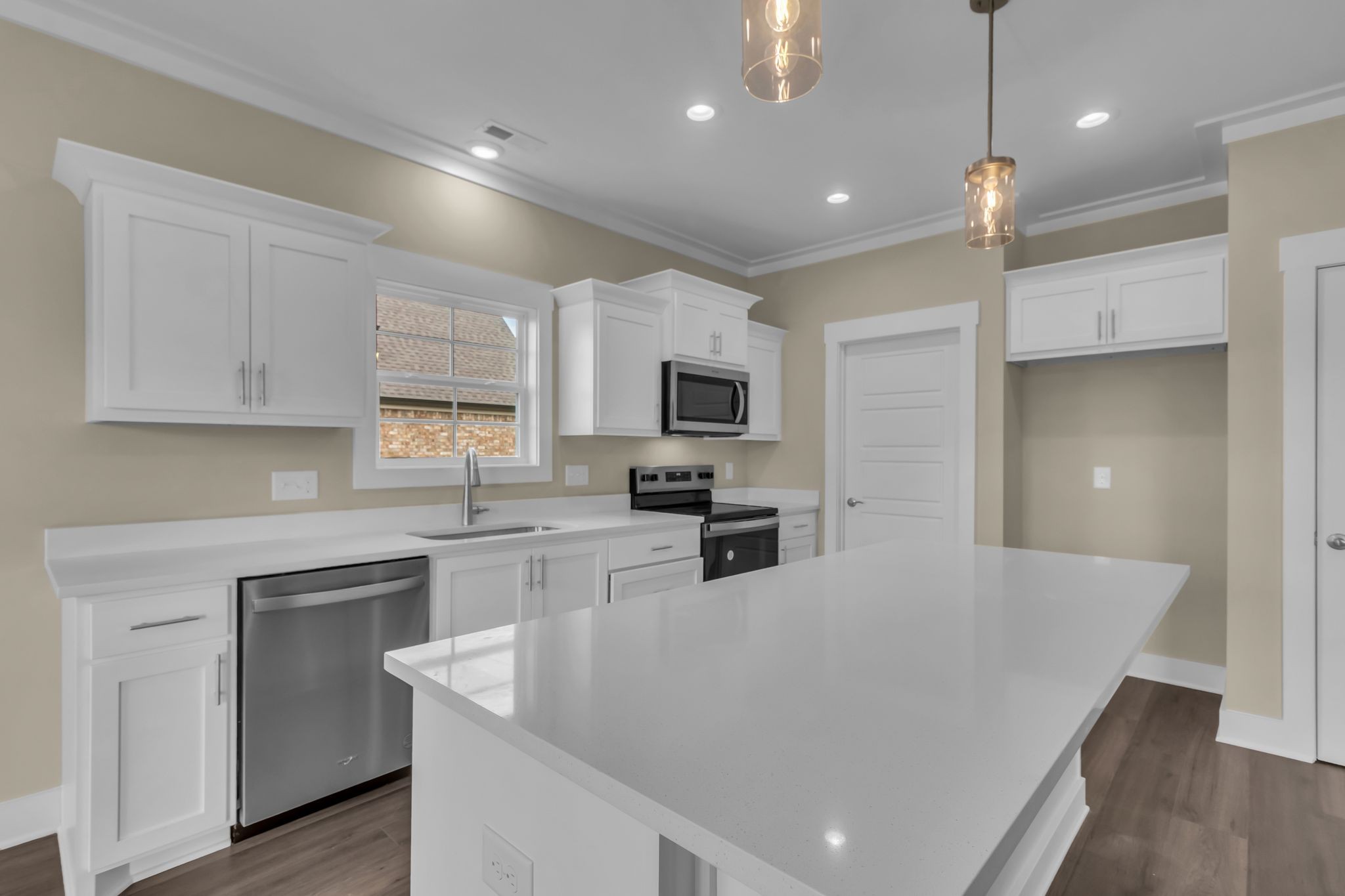 1176 Rimrock Road Smyrna, TN 37167 - Photo 14 of 40 an open kitchen with white cabinets and stainless steel appliances