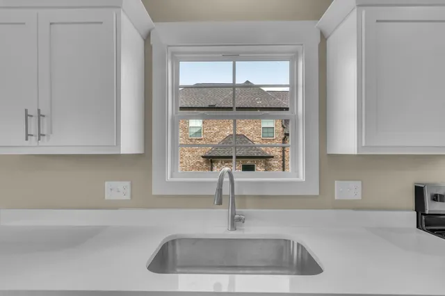 a kitchen with a sink and cabinet