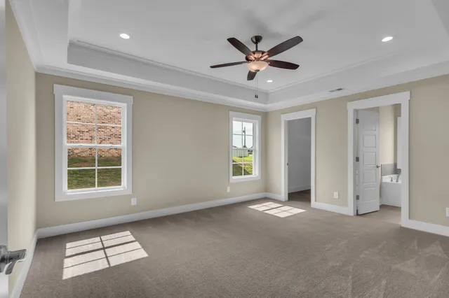 a view of a livingroom with a ceiling fan and window