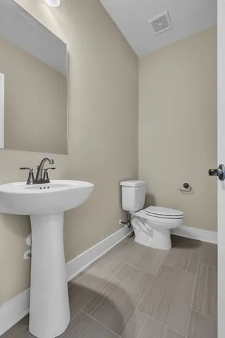 a bathroom with a sink toilet and a mirror