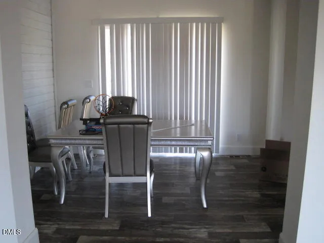 a view of a dining room with furniture and floor to ceiling window