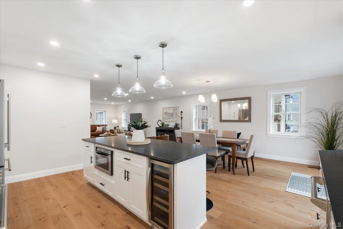 32 Ackerman Street Beacon, NY 12508 - Photo 16 of 50 a view of a dining room and livingroom with furniture wooden floor a rug and a chandelier