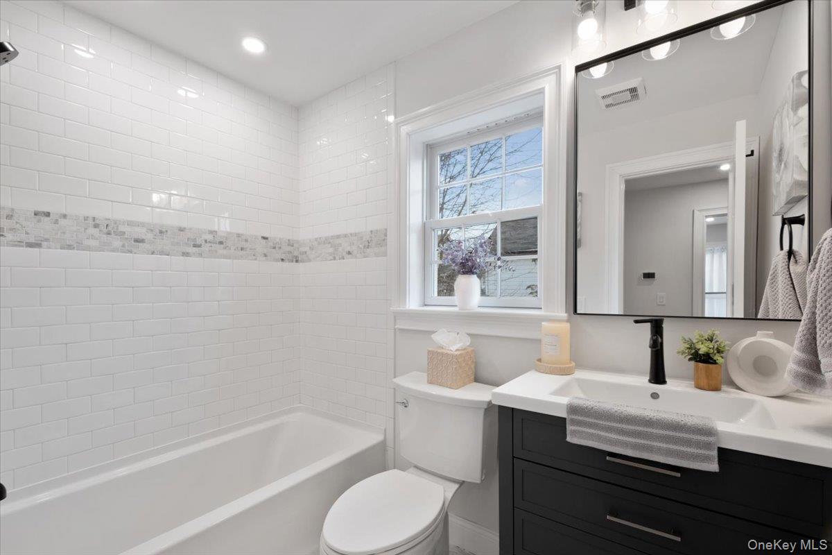 32 Ackerman Street Beacon, NY 12508 - Photo 25 of 50 a bathroom with a granite countertop sink toilet and bathtub
