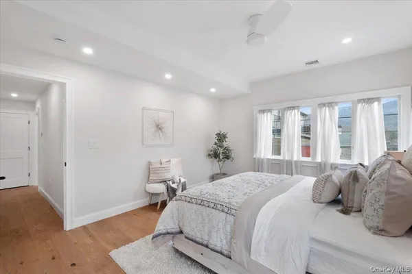 a bedroom with a bed and a potted plant