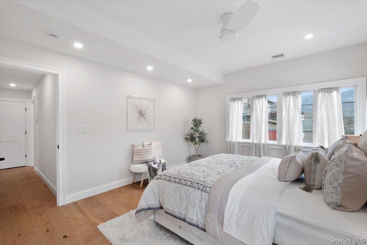 32 Ackerman Street Beacon, NY 12508 - Photo 28 of 50 a bedroom with a large bed and wooden floor