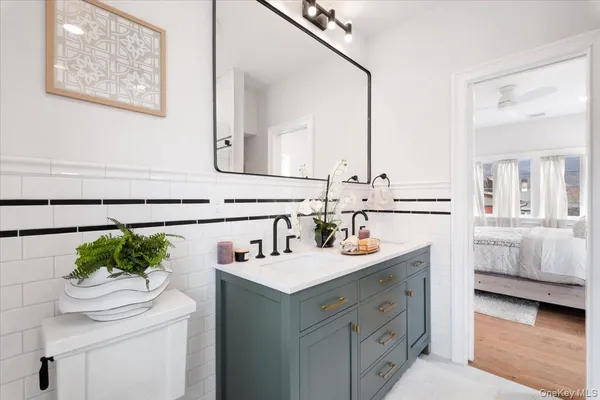 a bathroom with a tub shower sink and toilet