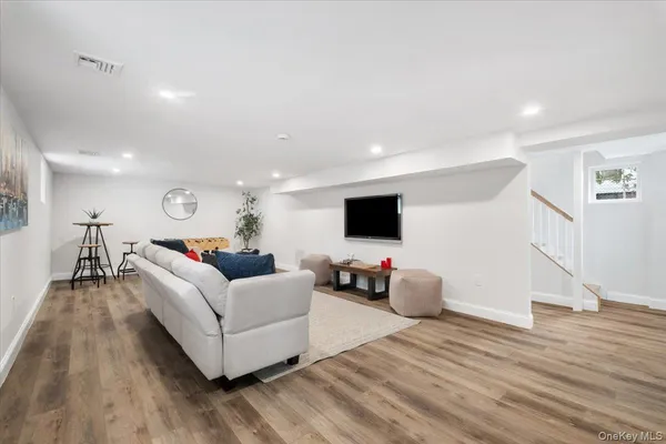 a dining room with furniture and wooden floor