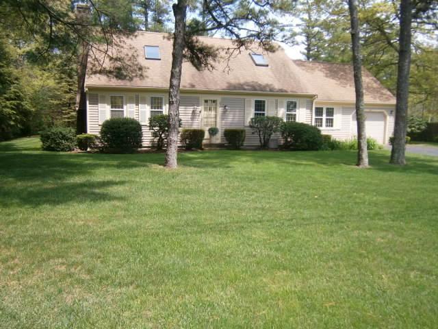 298 Nye Road Centerville, MA 02632 - Photo 1 of 26 a front view of a house with a garden