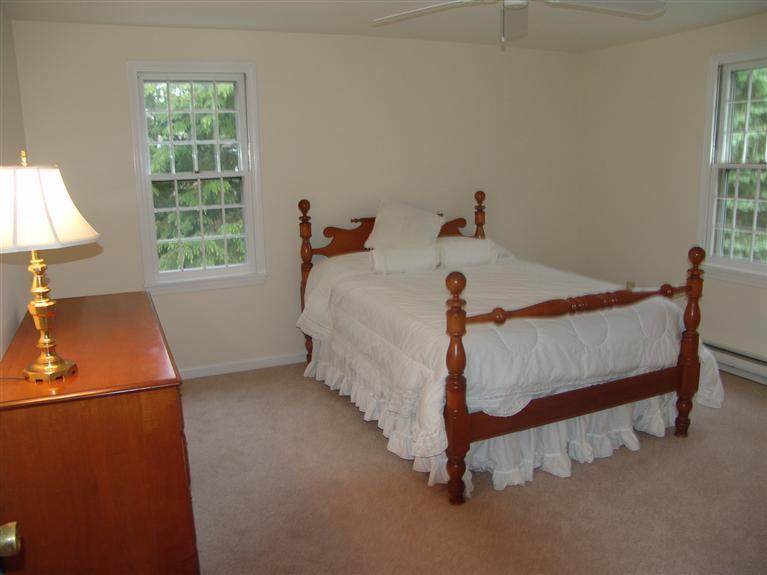 298 Nye Road Centerville, MA 02632 - Photo 15 of 26 a bed sitting in a bedroom next to a window