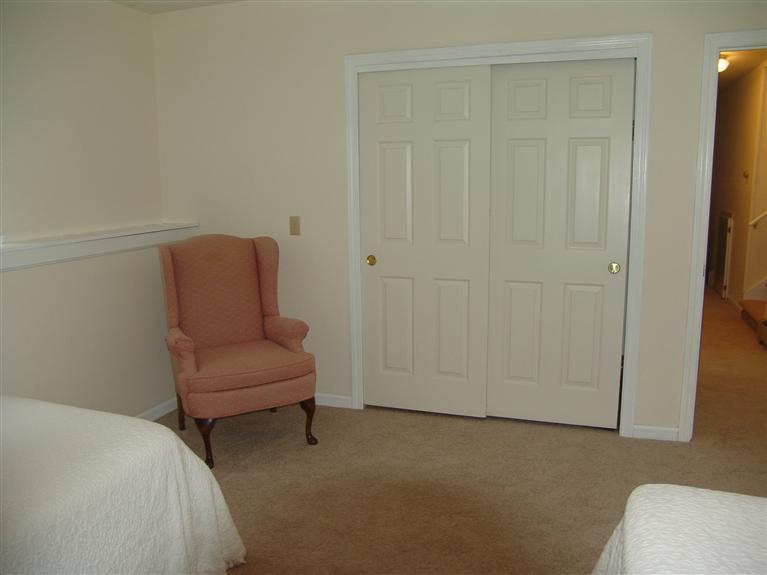 298 Nye Road Centerville, MA 02632 - Photo 24 of 26 a bedroom with a bed and a chair