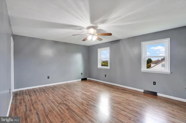 wooden floor in an empty room with a window