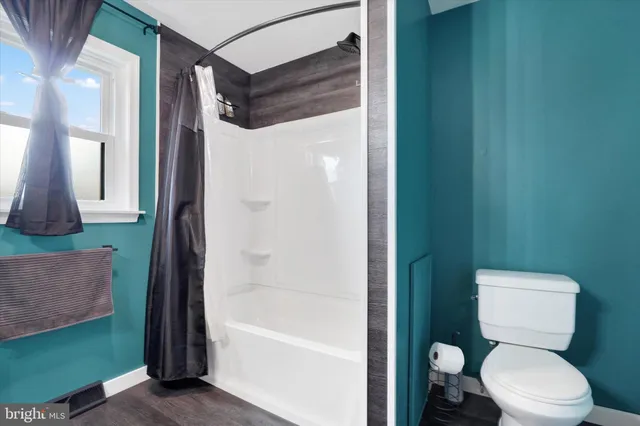 a bathroom with a sink a mirror and a shower